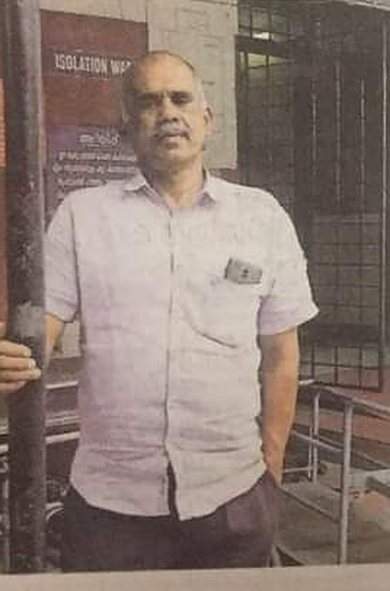 Mr. K. J. Peter beside the Isolation Ward sign at General Hospital, Ernakulam