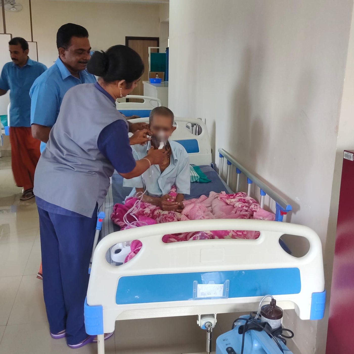 A nurse helping a resident with his nebuliser