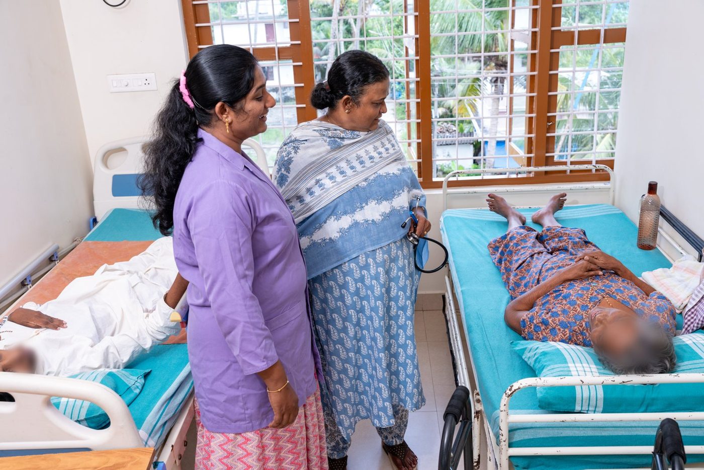 Dr. Annie and Jyolsna Mohan checking on a patient in the women's ward