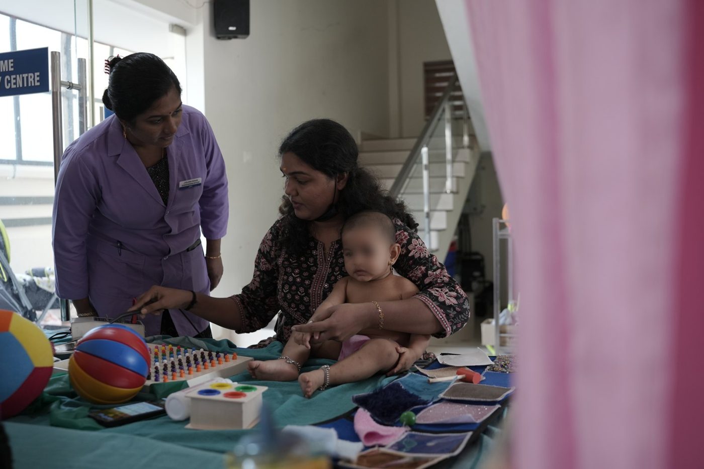 A physiotherapist working with a baby